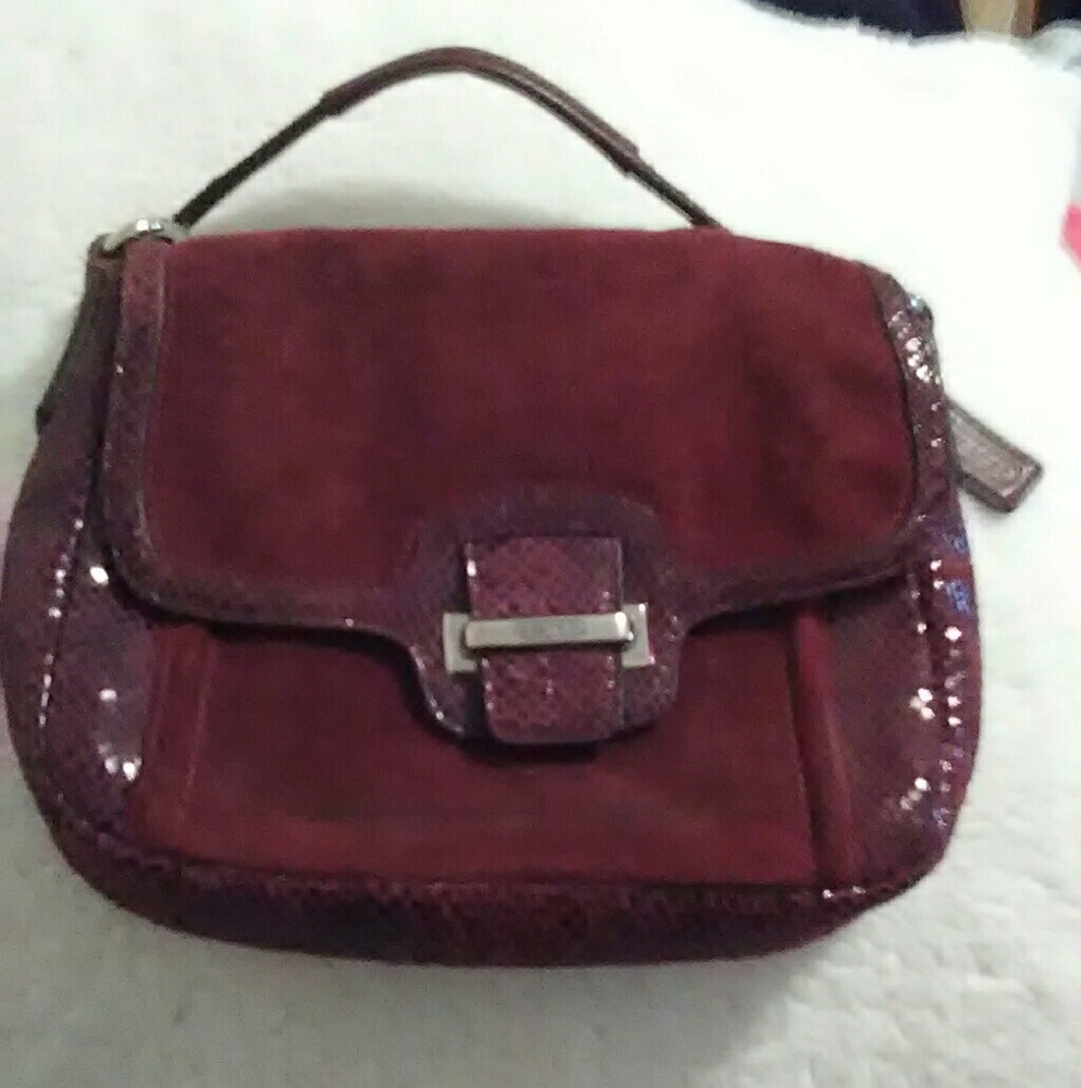Genuine Coach clutch in dark maroon.